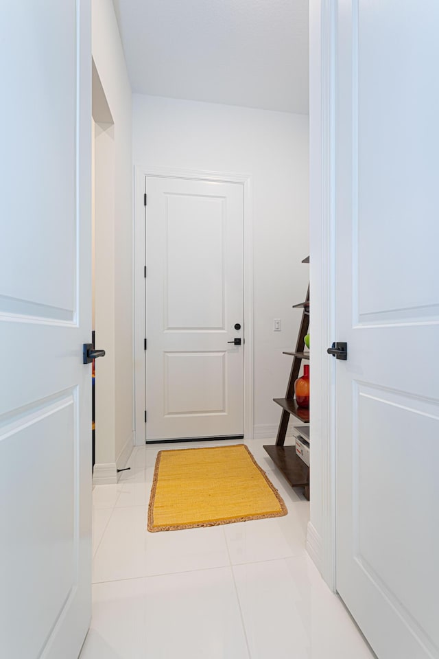 10815 Stellar Cir, Palm Beach Gardens, FL 33412 - entryway featuring tile patterned flooring and baseboards
