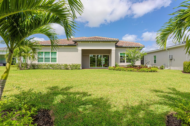 10815 Stellar Cir, Palm Beach Gardens, FL 33412 - rear view of house with stucco siding, a lawn, and a tile roof