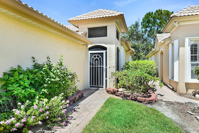 3611 NW Willow Creek Dr, Jensen Beach, FL 34957 - property entrance featuring stucco siding and a tile roof