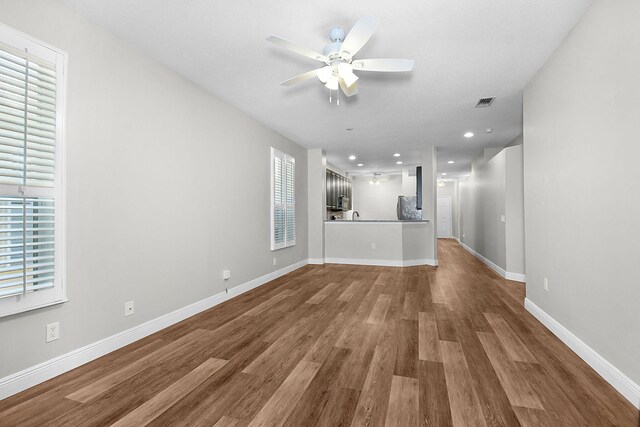 3611 NW Willow Creek Dr, Jensen Beach, FL 34957 - unfurnished living room featuring plenty of natural light, a ceiling fan, wood finished floors, and recessed lighting