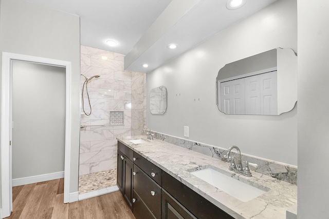 3611 NW Willow Creek Dr, Jensen Beach, FL 34957 - bathroom with double vanity, a walk in shower, wood finished floors, and recessed lighting