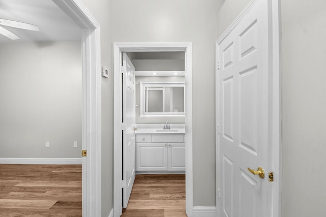 3611 NW Willow Creek Dr, Jensen Beach, FL 34957 - hall featuring a sink and wood finished floors