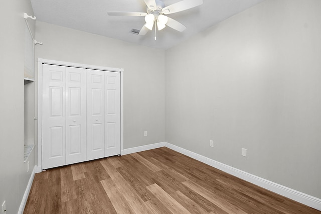 3611 NW Willow Creek Dr, Jensen Beach, FL 34957 - unfurnished bedroom featuring wood finished floors, a closet, and ceiling fan