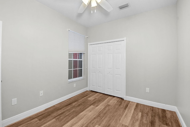 3611 NW Willow Creek Dr, Jensen Beach, FL 34957 - unfurnished bedroom with wood finished floors, a closet, and a ceiling fan