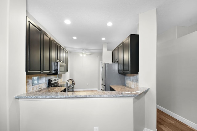 3611 NW Willow Creek Dr, Jensen Beach, FL 34957 - kitchen featuring appliances with stainless steel finishes, backsplash, light countertops, dark wood finished floors, and recessed lighting