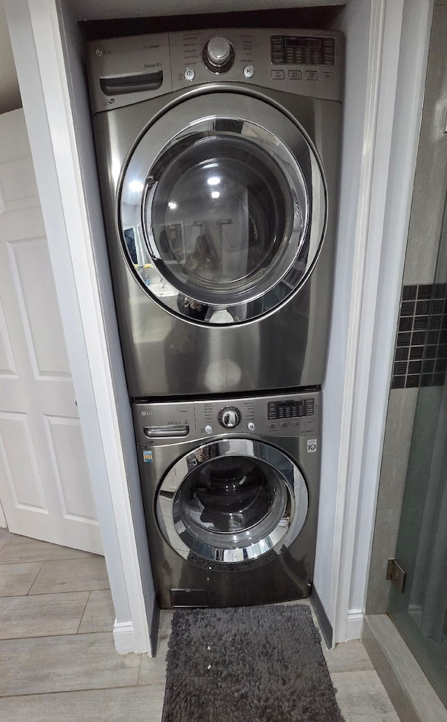 21404 Cypress Hammock Dr Unit 45E, Boca Raton, FL 33428 - laundry room featuring stacked washer / dryer and light wood finished floors