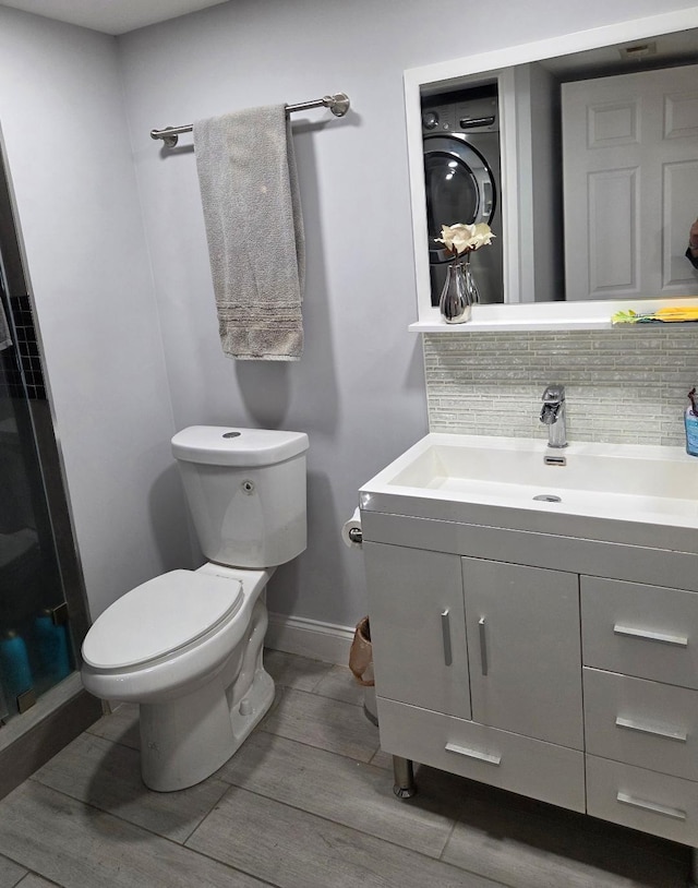 21404 Cypress Hammock Dr Unit 45E, Boca Raton, FL 33428 - bathroom with vanity, washer / clothes dryer, wood finished floors, tasteful backsplash, and a shower