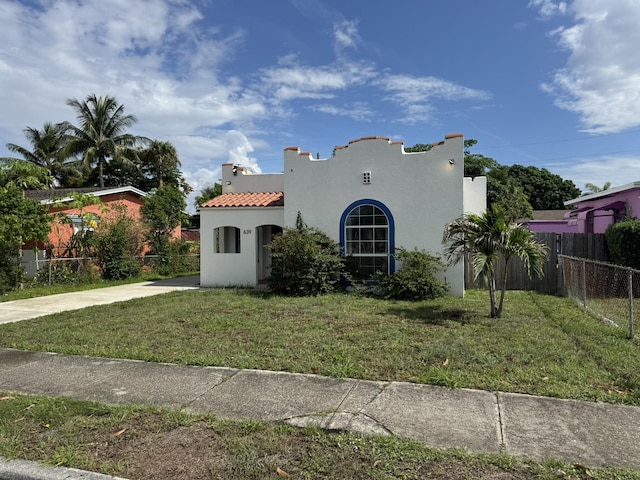 639 38th St, West Palm Beach, FL 33407 - mediterranean / spanish house with stucco siding and a tile roof