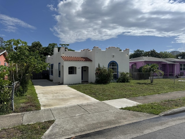 639 38th St, West Palm Beach, FL 33407 - mediterranean / spanish house featuring concrete driveway, stucco siding, and a tile roof