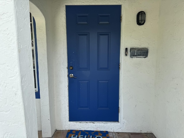 639 38th St, West Palm Beach, FL 33407 - doorway to property with stucco siding