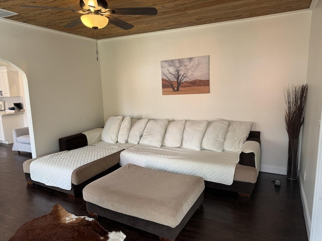 639 38th St, West Palm Beach, FL 33407 - living room with arched walkways, a ceiling fan, and dark wood-style flooring