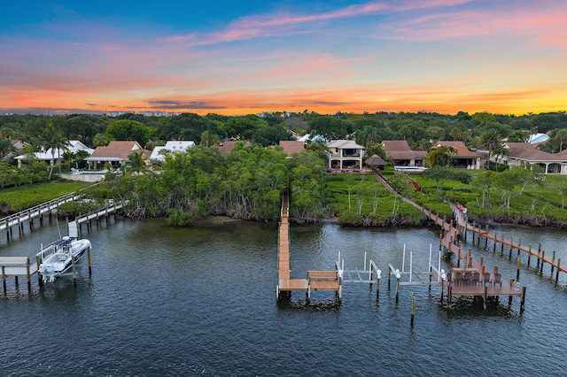 348 River Edge Rd, Jupiter, FL 33477 - dock with boat lift, a water view, and view of scattered trees