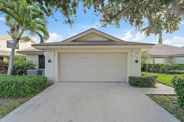 348 River Edge Rd, Jupiter, FL 33477 - ranch-style home featuring stucco siding, concrete driveway, and an attached garage