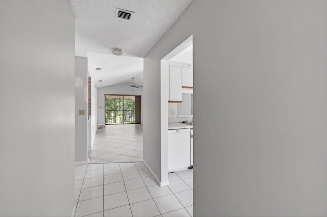 400 Club Cir Unit 201, Boca Raton, FL 33487 - corridor with light tile patterned floors, vaulted ceiling, and a textured ceiling