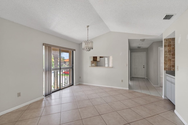 400 Club Cir Unit 201, Boca Raton, FL 33487 - spare room featuring a chandelier, light tile patterned floors, vaulted ceiling, and a textured ceiling