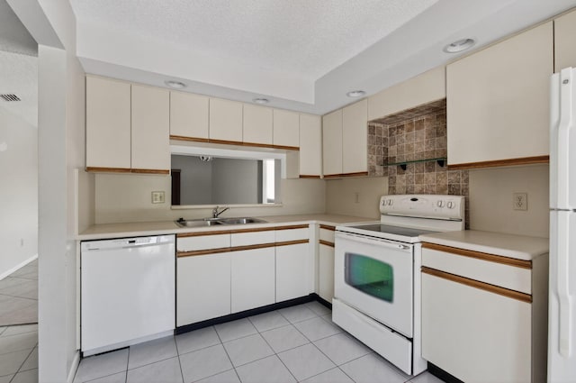 400 Club Cir Unit 201, Boca Raton, FL 33487 - kitchen featuring white appliances, cream cabinets, a textured ceiling, light countertops, and decorative backsplash