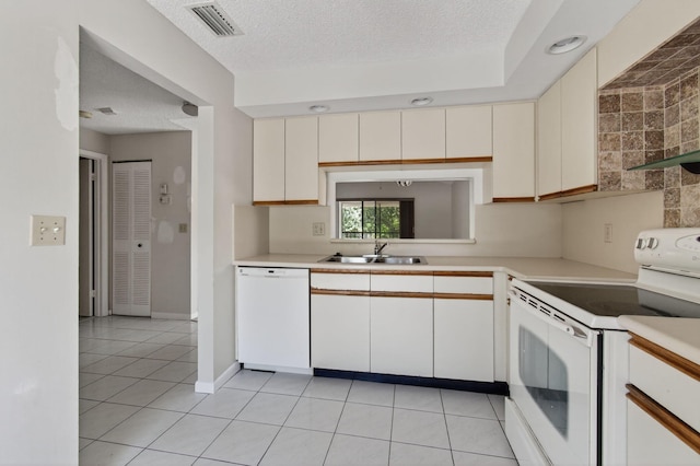 400 Club Cir Unit 201, Boca Raton, FL 33487 - kitchen with white appliances, light countertops, light tile patterned flooring, cream cabinets, and a textured ceiling