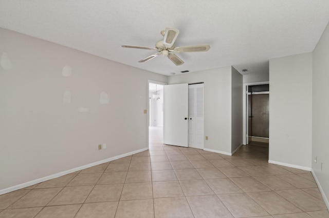 400 Club Cir Unit 201, Boca Raton, FL 33487 - unfurnished bedroom with a ceiling fan, light tile patterned floors, and a textured ceiling