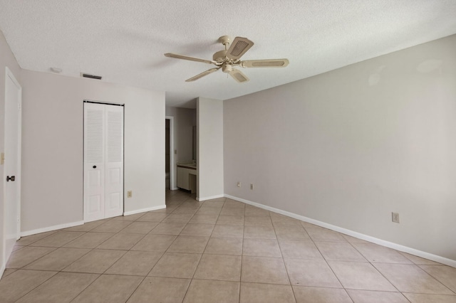 400 Club Cir Unit 201, Boca Raton, FL 33487 - unfurnished bedroom featuring a textured ceiling, a ceiling fan, light tile patterned flooring, and a closet