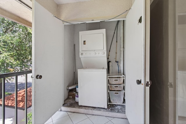 400 Club Cir Unit 201, Boca Raton, FL 33487 - laundry area featuring stacked washing machine and dryer, plenty of natural light, and tile patterned flooring