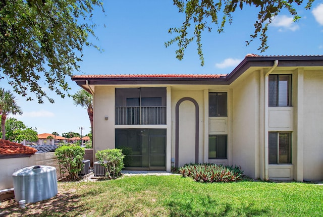 400 Club Cir Unit 201, Boca Raton, FL 33487 - back of property with stucco siding, a yard, and a tiled roof