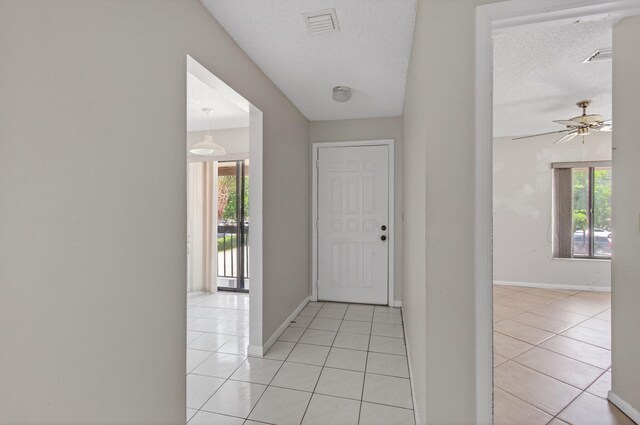 400 Club Cir Unit 201, Boca Raton, FL 33487 - foyer entrance featuring healthy amount of natural light, light tile patterned floors, a ceiling fan, and a textured ceiling