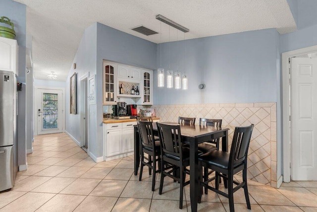 2997 SW Collings Dr, Port Saint Lucie, FL 34953 - dining room with a textured ceiling and light tile patterned floors