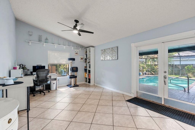 2997 SW Collings Dr, Port Saint Lucie, FL 34953 - home office featuring french doors, ceiling fan, lofted ceiling, a textured ceiling, and light tile patterned floors