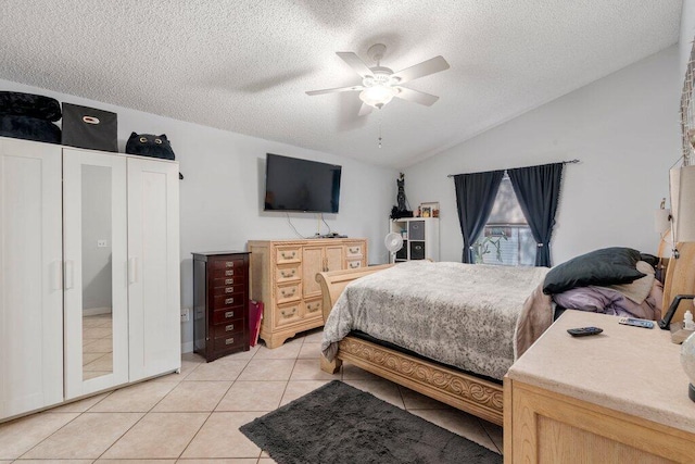 2997 SW Collings Dr, Port Saint Lucie, FL 34953 - bedroom featuring vaulted ceiling, a textured ceiling, light tile patterned floors, and ceiling fan