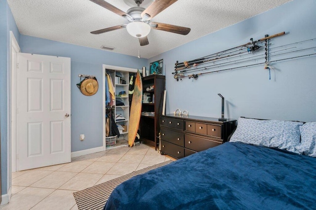 2997 SW Collings Dr, Port Saint Lucie, FL 34953 - bedroom with a textured ceiling, light tile patterned flooring, a closet, and ceiling fan