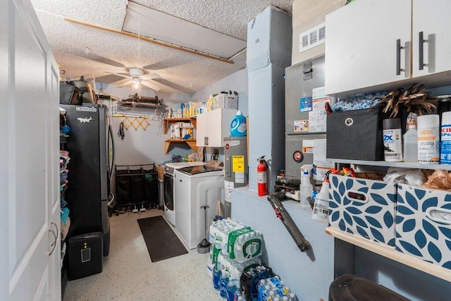 2997 SW Collings Dr, Port Saint Lucie, FL 34953 - kitchen featuring washer and dryer, freestanding refrigerator, a ceiling fan, white cabinets, and electric water heater