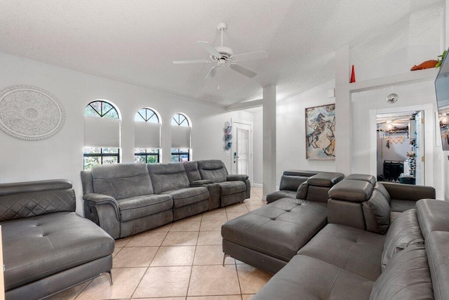 2997 SW Collings Dr, Port Saint Lucie, FL 34953 - living room featuring lofted ceiling, ceiling fan, light tile patterned flooring, and a textured ceiling