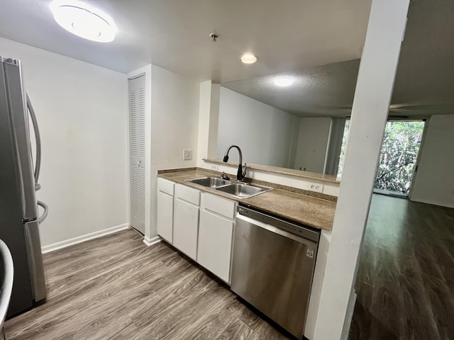 1100 Scotia Dr Unit 102, Hypoluxo, FL 33462 - kitchen with stainless steel appliances, wood finished floors, and white cabinetry