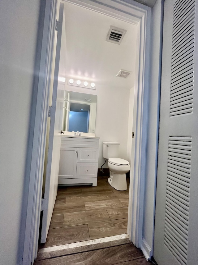 1100 Scotia Dr Unit 102, Hypoluxo, FL 33462 - half bathroom with a heating unit, wood finished floors, and vanity