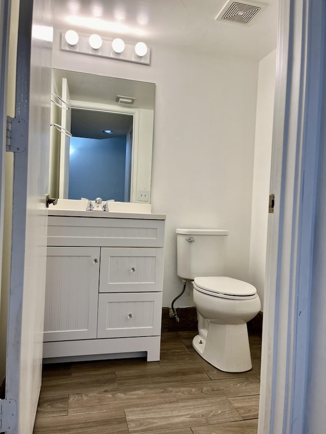 1100 Scotia Dr Unit 102, Hypoluxo, FL 33462 - half bath featuring vanity and wood finished floors