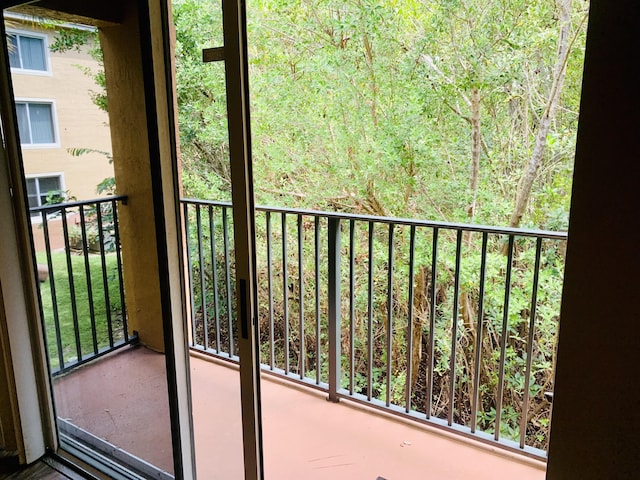 1100 Scotia Dr Unit 102, Hypoluxo, FL 33462 - balcony featuring a view of trees