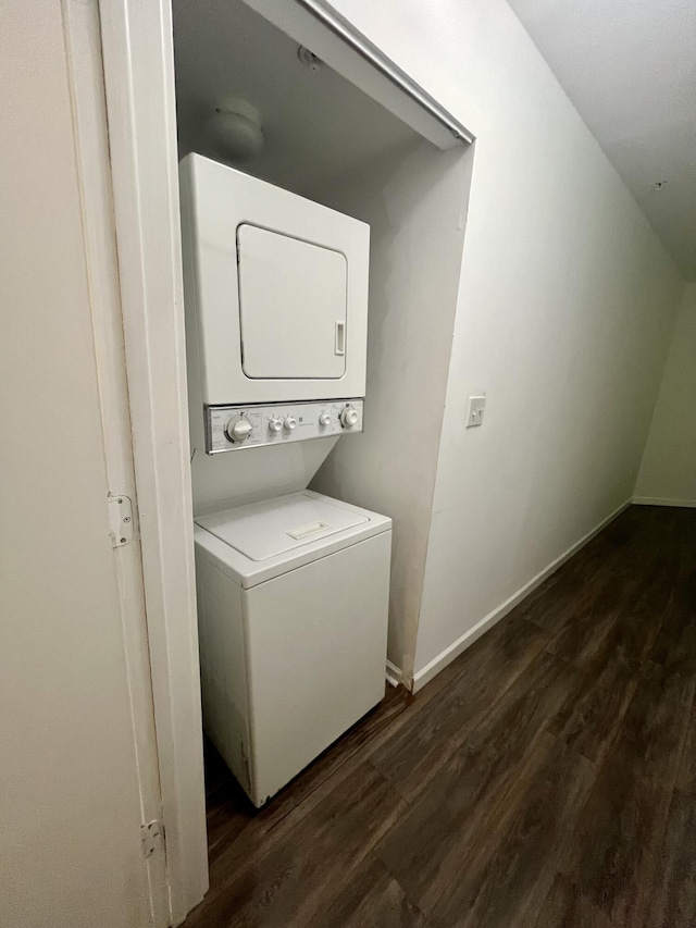 1100 Scotia Dr Unit 102, Hypoluxo, FL 33462 - washroom with stacked washing machine and dryer and dark wood-style flooring