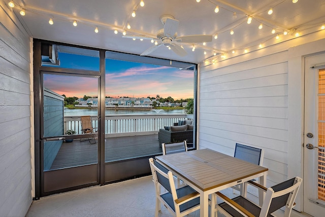1219 Ocean Dunes Cir, Jupiter, FL 33477 - dining area featuring a water view, wooden walls, and a ceiling fan