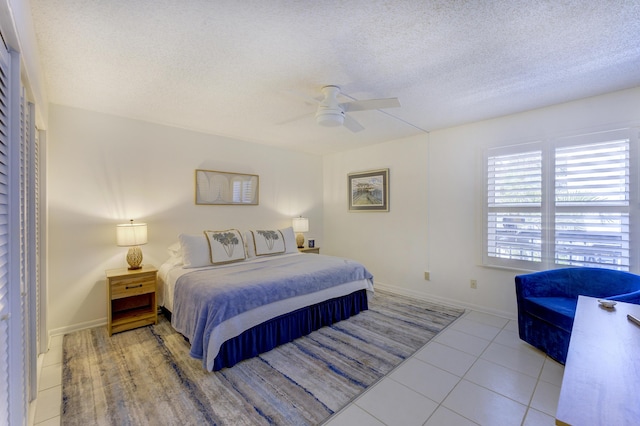 2571 NE Ocean Blvd Unit 104, Stuart, FL 34996 - tiled bedroom featuring a textured ceiling and a ceiling fan