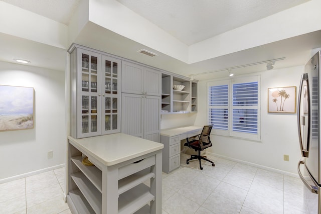 2571 NE Ocean Blvd Unit 104, Stuart, FL 34996 - office area with light tile patterned floors, built in study area, and track lighting