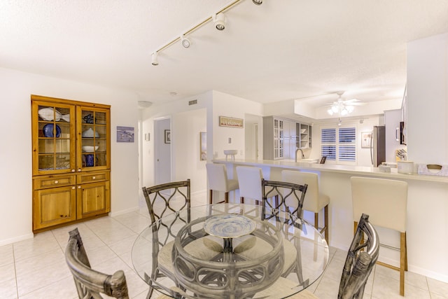2571 NE Ocean Blvd Unit 104, Stuart, FL 34996 - dining area with ceiling fan, light tile patterned flooring, and track lighting