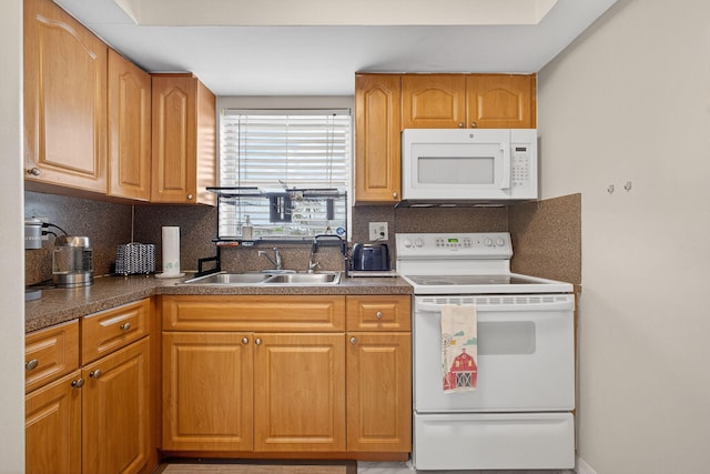 2611 W Barkley Dr W Unit C, West Palm Beach, FL 33415 - kitchen featuring white appliances, tasteful backsplash, and dark countertops