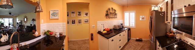 6303 SE Williamsburg Dr Unit 201, Hobe Sound, FL 33455 - kitchen featuring white cabinets, dark countertops, ceiling fan, and wall oven