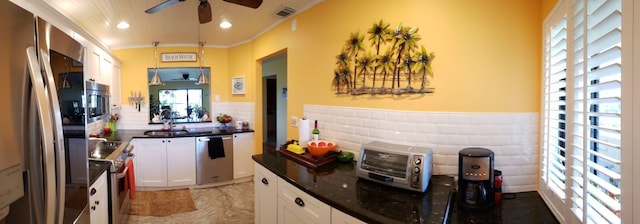6303 SE Williamsburg Dr Unit 201, Hobe Sound, FL 33455 - kitchen featuring appliances with stainless steel finishes, a ceiling fan, white cabinets, recessed lighting, and ornamental molding