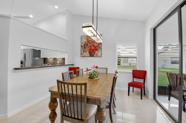 7585 Lexington Club Blvd Unit A, Delray Beach, FL 33446 - dining room with light tile patterned floors, high vaulted ceiling, and recessed lighting