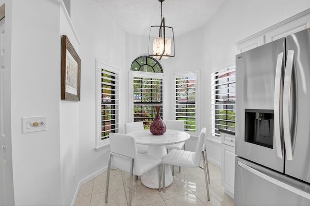 7585 Lexington Club Blvd Unit A, Delray Beach, FL 33446 - dining area with a chandelier, light tile patterned floors, and a textured ceiling