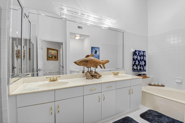 7585 Lexington Club Blvd Unit A, Delray Beach, FL 33446 - full bathroom with double vanity, a garden tub, and tile patterned flooring