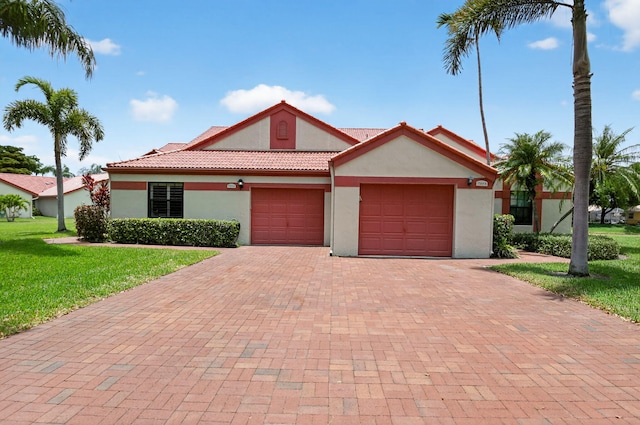 7585 Lexington Club Blvd Unit A, Delray Beach, FL 33446 - view of front of house with decorative driveway, stucco siding, an attached garage, a front lawn, and a tile roof
