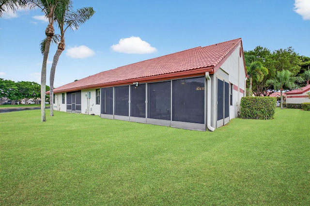 7585 Lexington Club Blvd Unit A, Delray Beach, FL 33446 - rear view of property with a tile roof, a lawn, and a sunroom