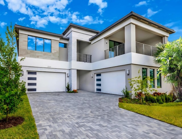 20140 Casa De Campo Ln, Boca Raton, FL 33434 - contemporary house featuring an attached garage, a balcony, stucco siding, and decorative driveway
